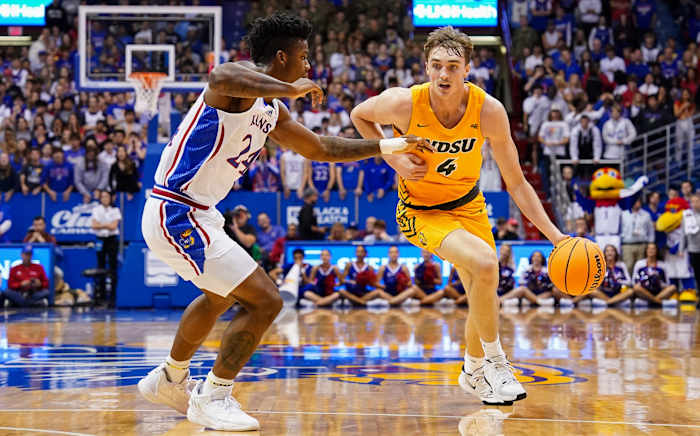Nov 10, 2022; Lawrence, Kansas, USA; North Dakota State Bison forward Grant Nelson (4) drives against Kansas Jayhawks forward K.J. Adams Jr. (24) during the first half at Allen Fieldhouse. Mandatory Credit: Jay Biggerstaff-USA TODAY Sports